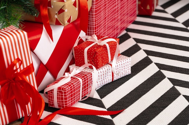 Photo pile of wrapped presents under the christmas tree