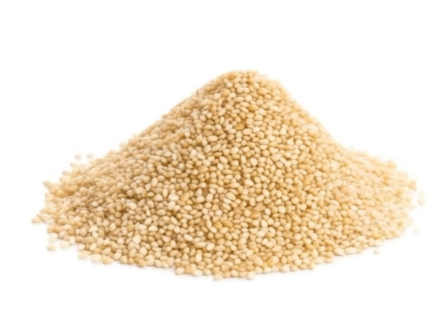 A pile of yellow sesame seeds on a white background