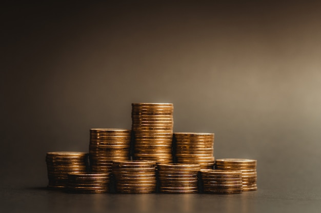 piles of coins in dark room