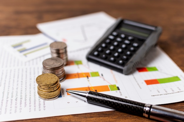 Photo piles of different coins with stationery decoration