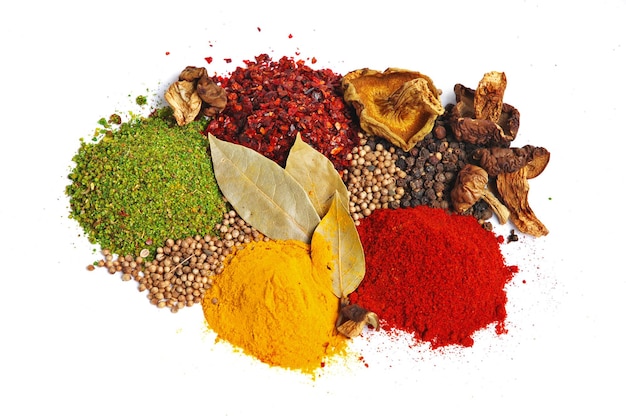 piles of spices parsley red paprika whole black pepper white coriander curcuma laurel leaves