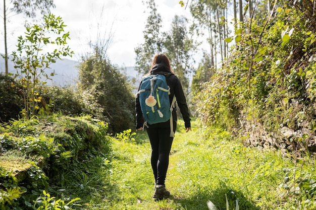 Pilgrim brunette woman doing the Camino de Santiago Hike way of st james