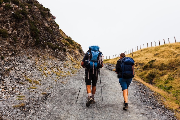 Pilgrims walking in the mountains of the Pyrenees Camino de Santiago