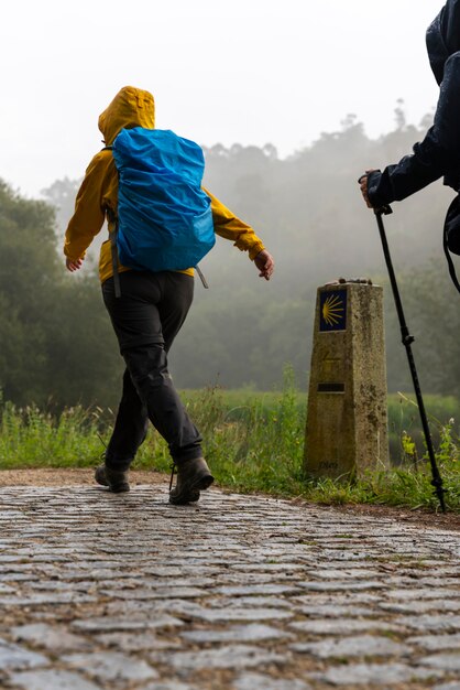 Pilgrims walking on the way to St James (Santiago) on a foggy day in Galicia