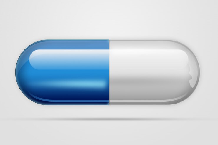 Photo a pill in  forma capsule of blue color,a light 