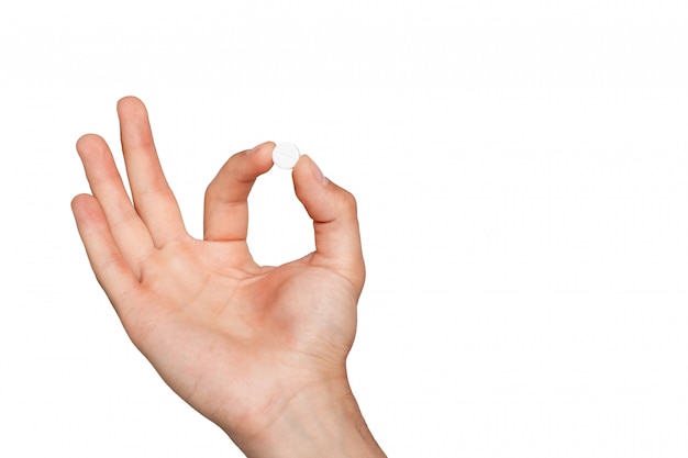 Photo pill in man's hand on white