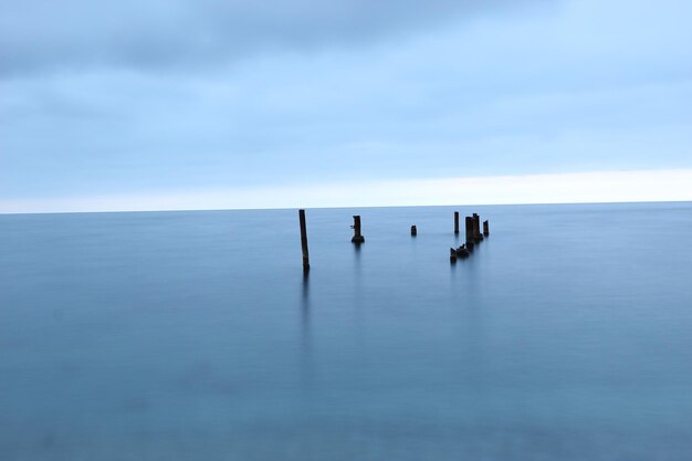 The pillars of the old pier in the sea at dawn  Shooting on long focus