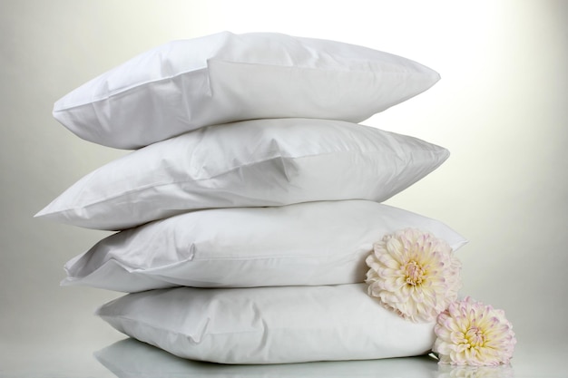 Pillows and flowers on grey background