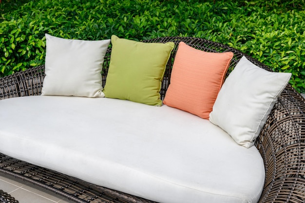 Pillows on mattress and weave wooden sofa