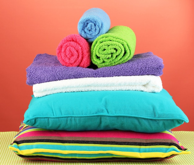 Pillows and towels on red wall