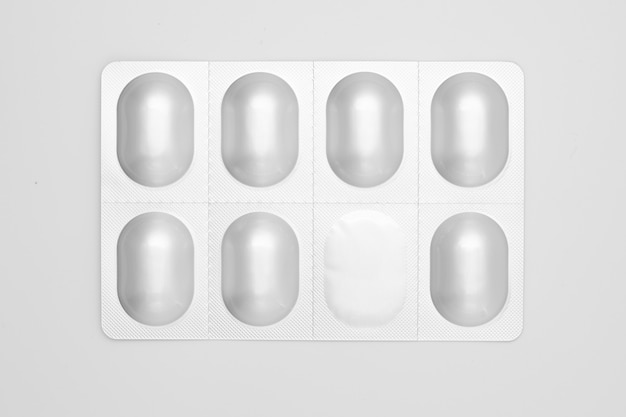 Photo pills in aluminum blister pack isolated on white.