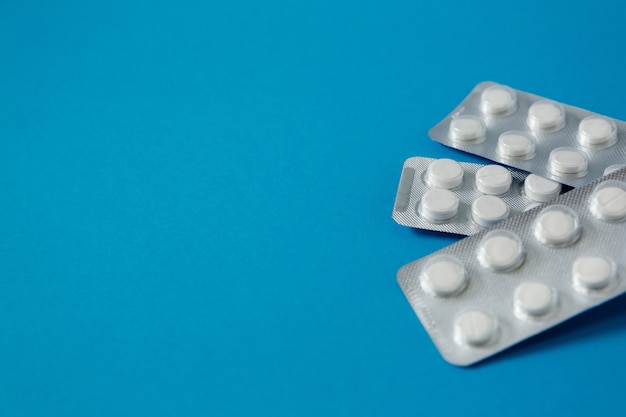 Pills in blister pack on blue background