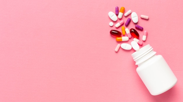 Pills bottle on pink background