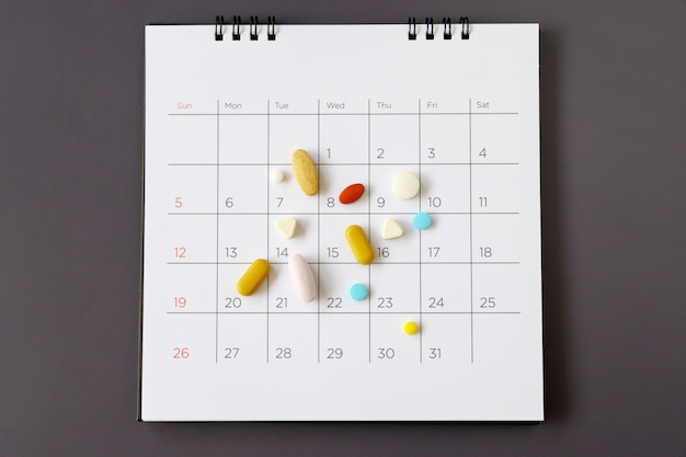 Pills on a calendar background. concept Healthcare