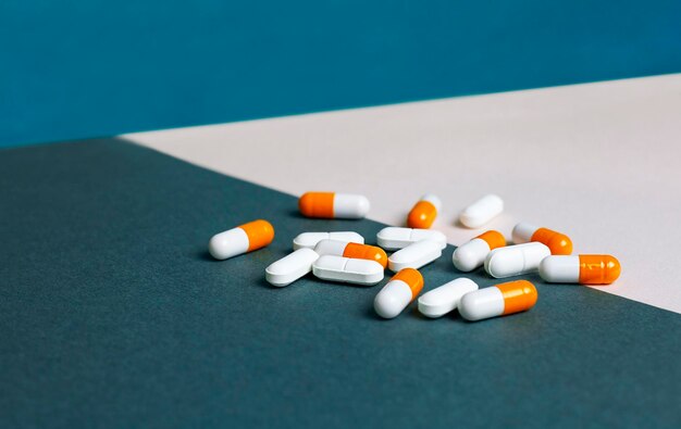 pills and capsules on a blue combined background close-up