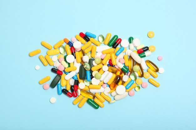 Pills on a colored background top view medicine treatment illness