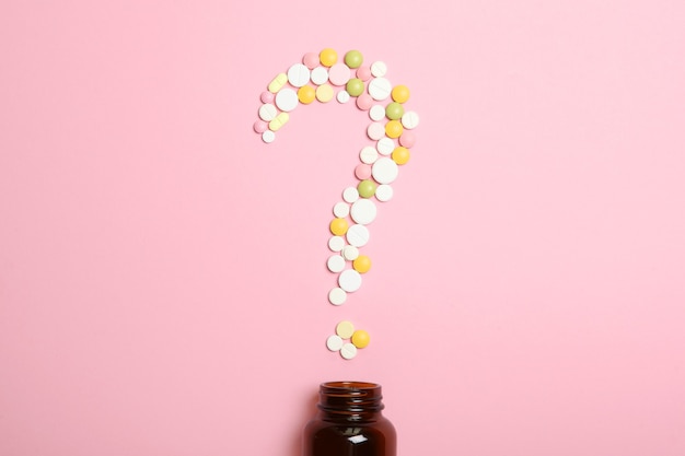 Pills on a colored background top view medicine treatment illness