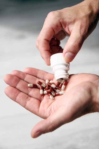 Pills in the hands of the patient men