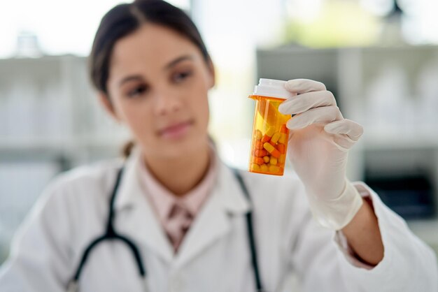 pills healthcare and doctor with medication in clinic with treatment for diagnosis in container medicine tablets and professional woman medical worker with life extension drugs in hospital office