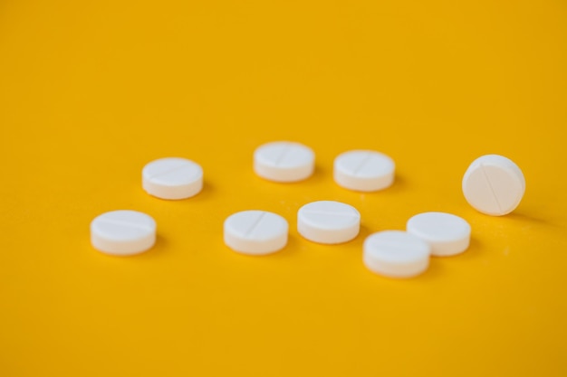 Pills isolated on yellow background