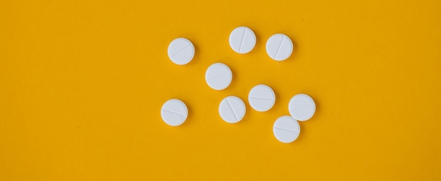 Pills isolated on yellow background