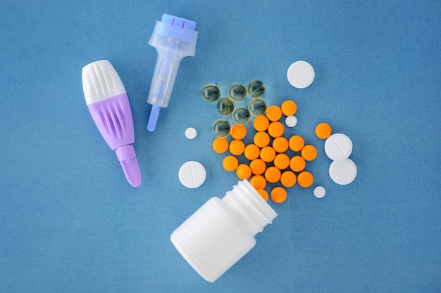 Pills and lancets adult and children on a blue background.