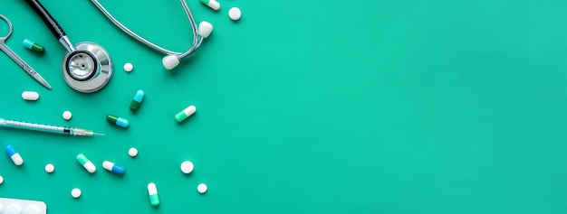 Pills and medical equiupments on green banner background