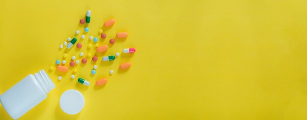 Pills and medicine bottles on a yellow backgroundAll kinds of drugs to be put into the medicine