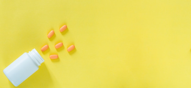 Pills and medicine bottles on a yellow backgroundAll kinds of drugs to be put into the medicine