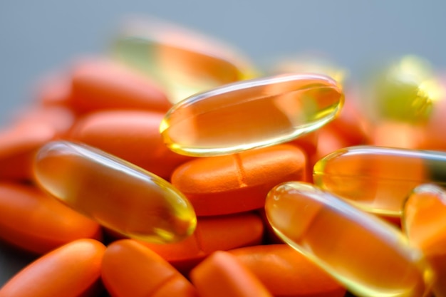 Pills mix background painkillers and prescription drugs concept orange and yellow capsules