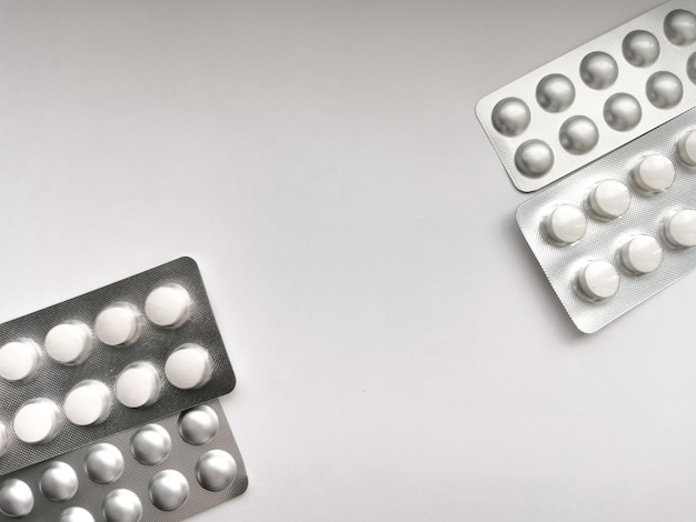 Pills in packaging on a gray background disease treatment the fight against coronavirus