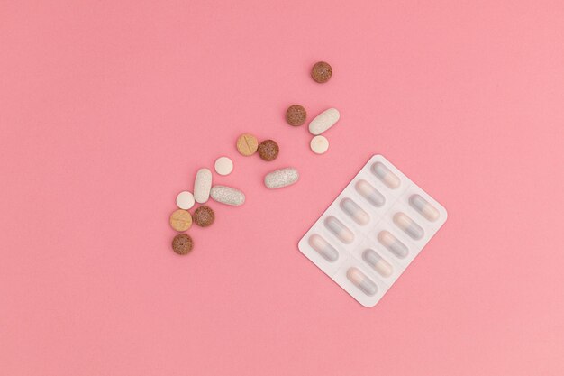 Pills on pink background