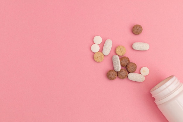 Pills on pink background