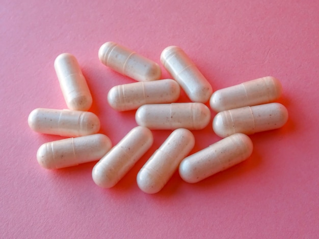 Pills on a pink surface