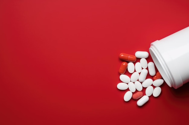 Pills on red background