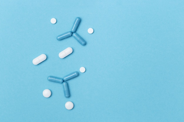 pills shaped of molecule on blue surface