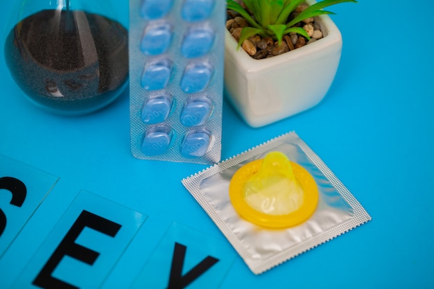 Pills that promote sexual health for men for a long time on blue background