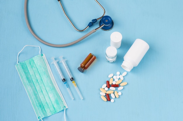 Pills, two syringes, a stethoscope and a mask