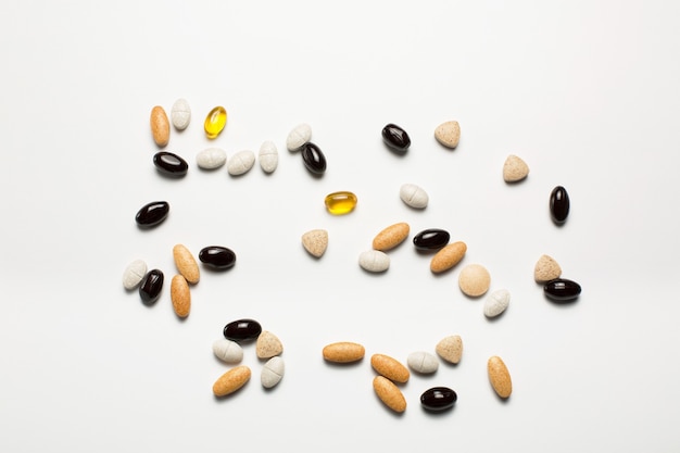 Pills, vitamins, fish oil, nutritional supplements on white background