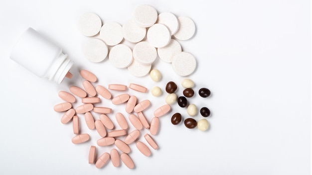 Pills with bottle isolated on white Macro top down view with copy space