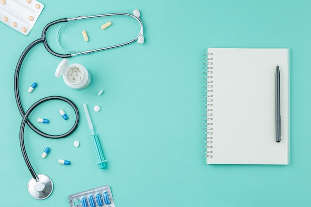 Pills with a stethoscope on the doctor table