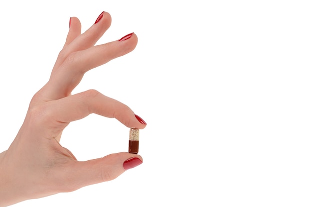 Pills in woman hand isolated on white