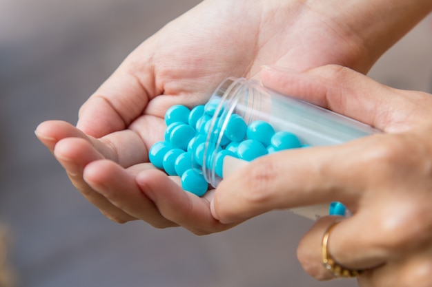 Pills in woman hand