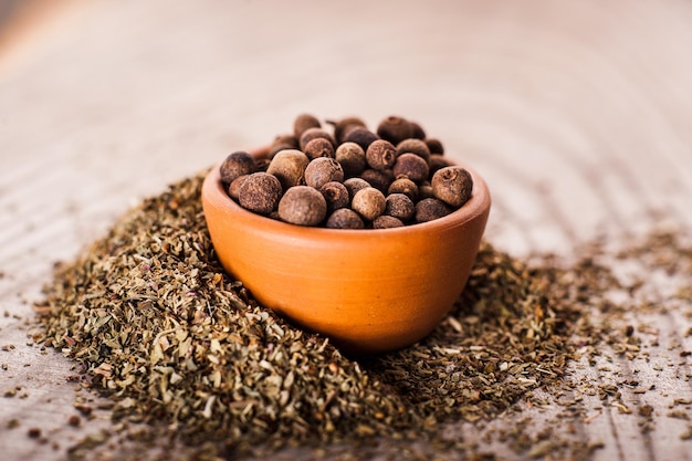 Pimento pepper on wooden background Dried basil