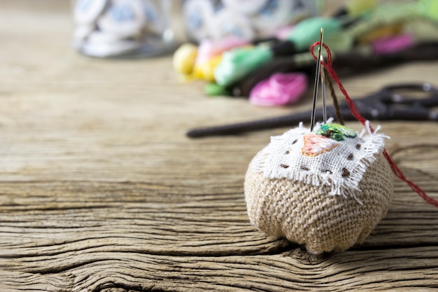 Pin cushion on old wood table