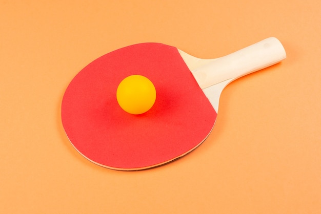 Pin pong on an orange background.  Top view.