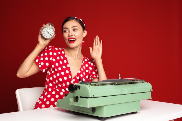 Pin up girl typing on a typewriter