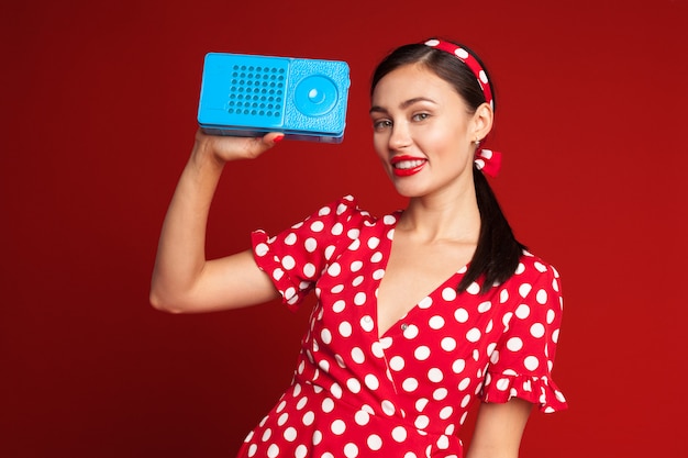 Pin up style girl listening old radio