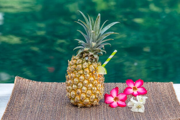 Pina colada cocktail in fresh pineapple near swimming pool closeup Island Bali Indonesia