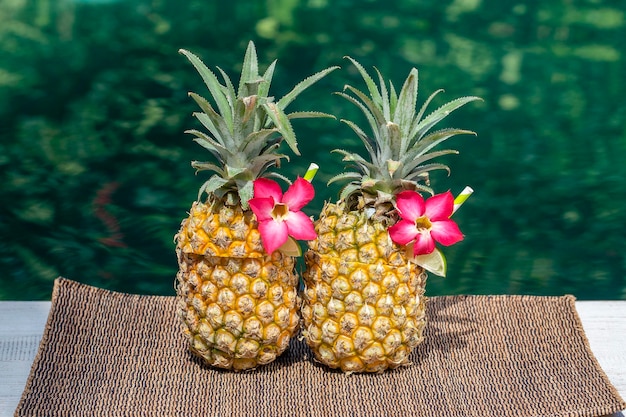 Pina colada cocktail in fresh pineapples near swimming pool close up Island Bali Indonesia